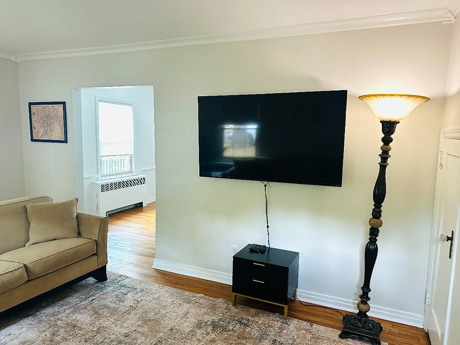 Living room w/ 2 couches, and 60 inch smart tv; perfect for relaxation.