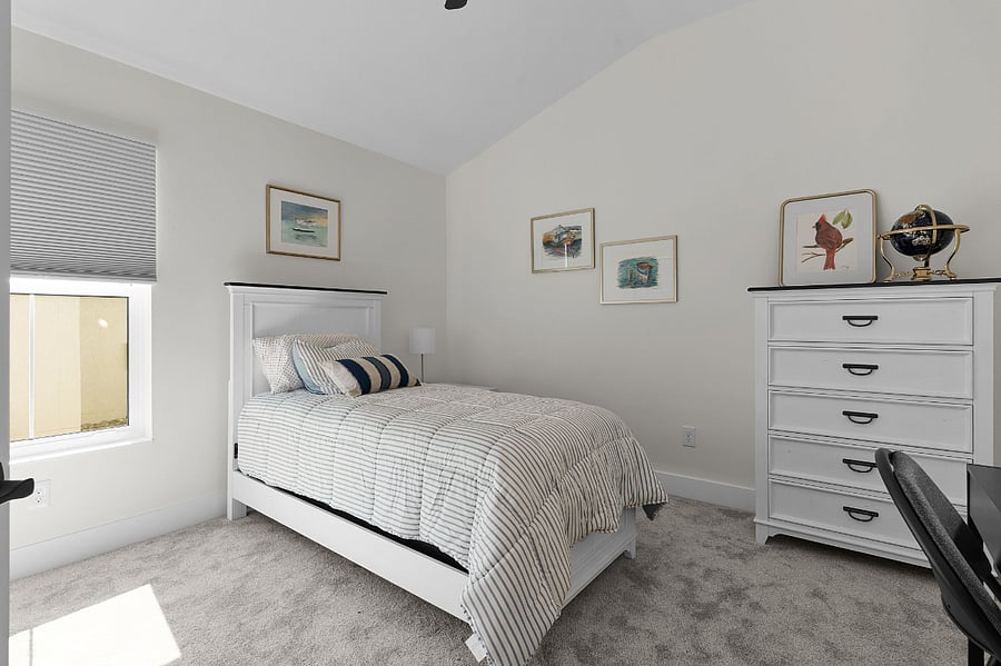 Guest bedroom with twin bed, dresser.