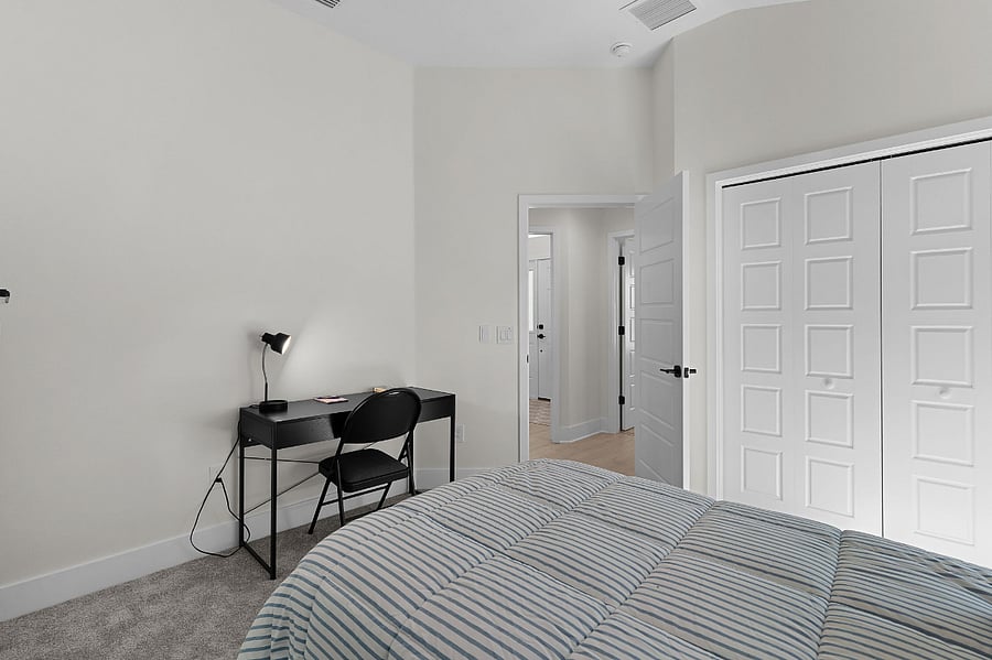 Twin Guest bedroom with desk/workspace.