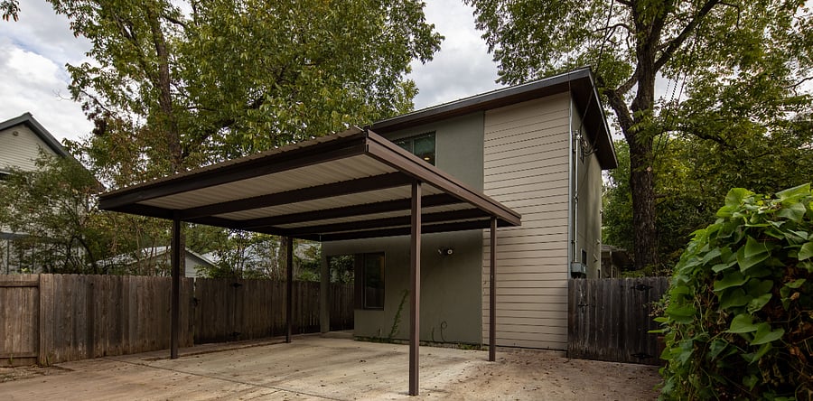 Exterior of house showing uncovered parking area (covered parking not included)