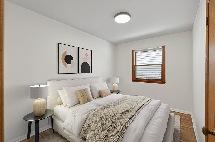 The primary bedroom features a king bed, dresser, mirror, and lounge chair!