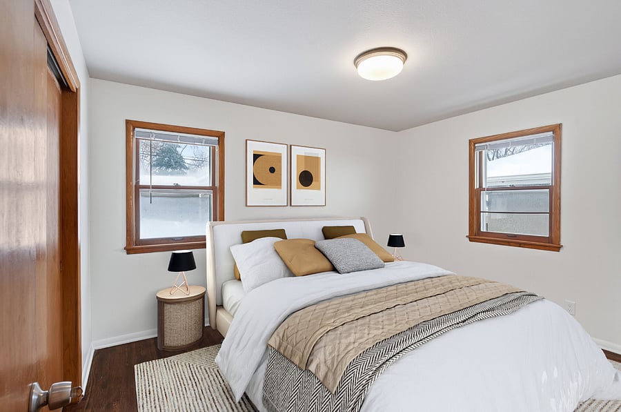The second bedroom features a queen bed, dresser, mirror, and lounge chair!