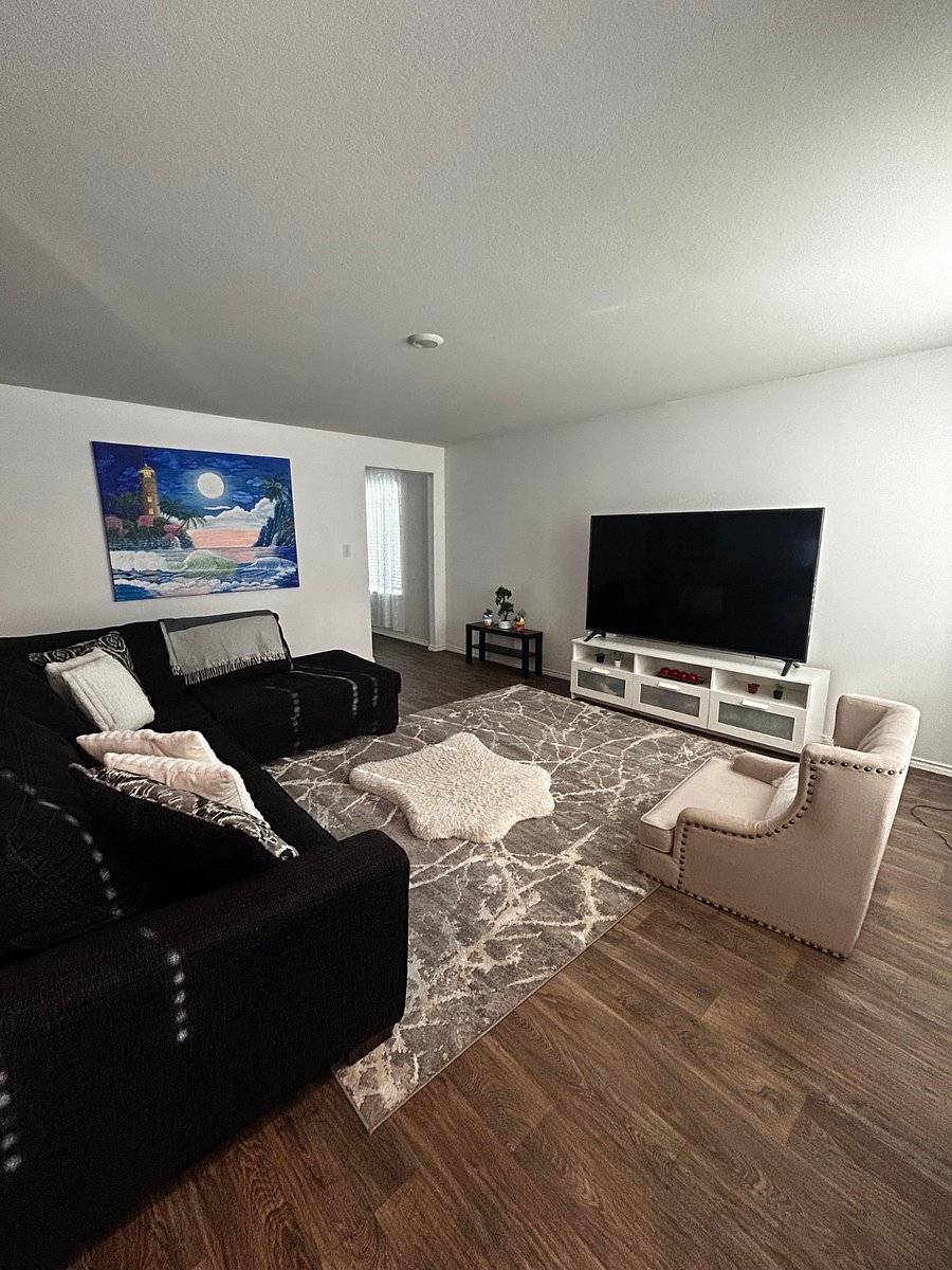 Living room area with TV, board games and backyard view.