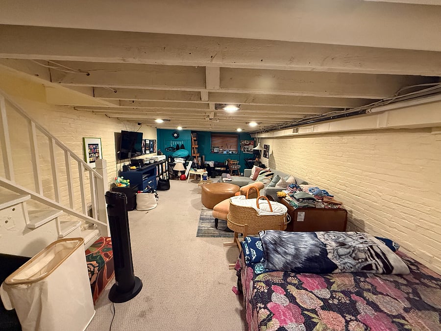 basement with office, living space and queen bed