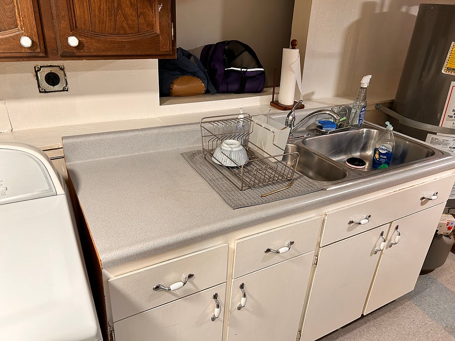 Large stainless steel sink for washing dishes.