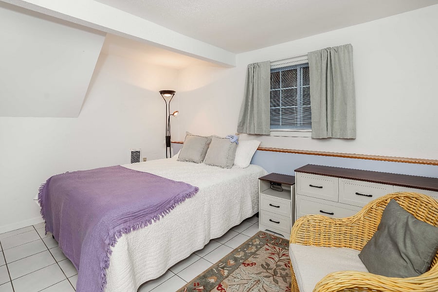 Bedroom with comfortable new queen, bed, lighted bed stand with charging station, large six-drawer dresser
