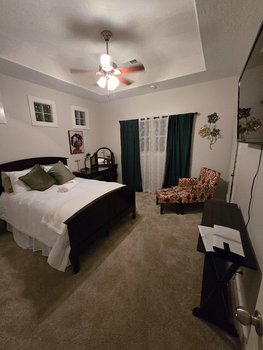 Private primary suite featuring a spacious bedroom with comfortable furnishings and a cozy seating area. The en-suite bathroom offers a relaxing soaking tub and separate walk-in shower, creating a perfect retreat for rest and relaxation.