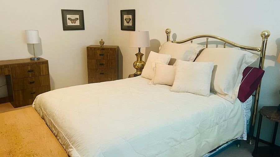 Oversized Bedroom D on Floor 2 with large closet, Double Bed, dresser, bureau, desk, chair, trunk, two night stands, three lamps, Entertainment Cabinet, overhead light, Very Spacious and Bright and Airy near shared with one occupant hall bath on right. 