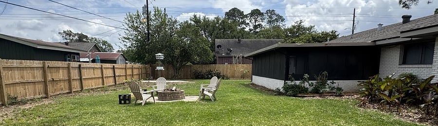Fenced in private backyard. Brick fire pit with Adirondack chairs