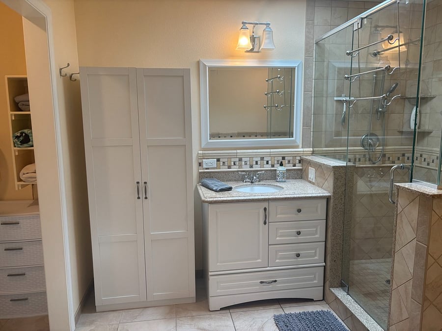 bathroom sink/vanity, storage cabinet, shower