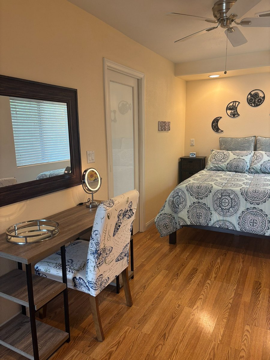 dediated bedroom space, adjacent bathroom (pocket door), vanity w/ mirror & chair