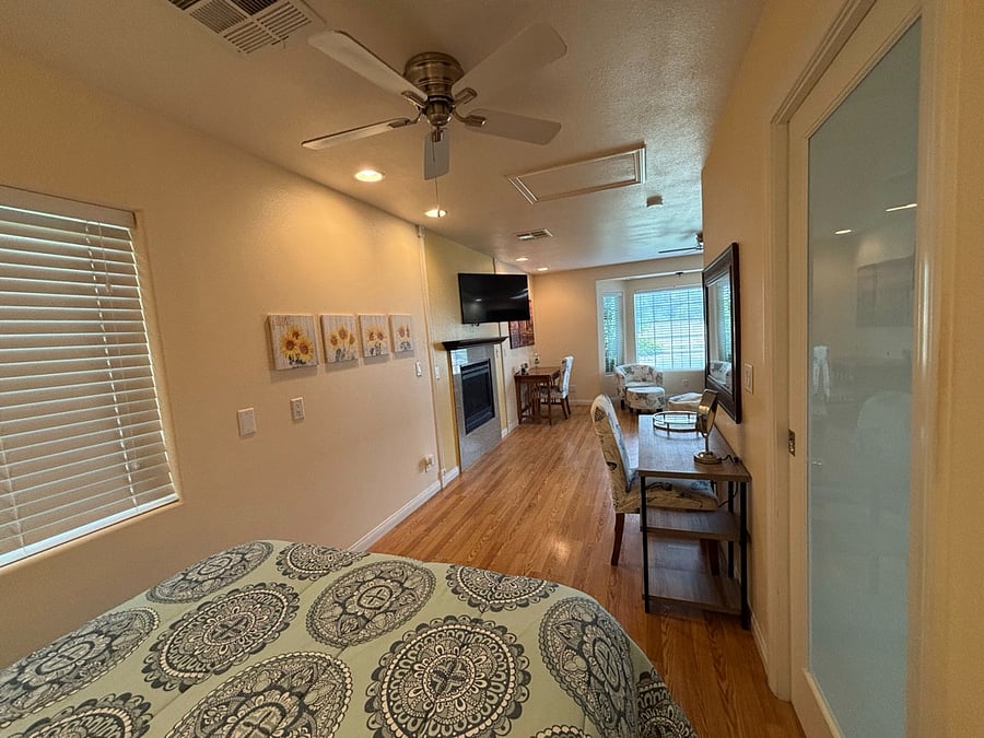 View from bedroom space to living space w/ swivel mount TV