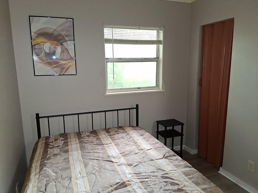 Private bedroom w/ a window for natural light, a full-size bed and a closet for convenient in-room storage, a desk and chair.