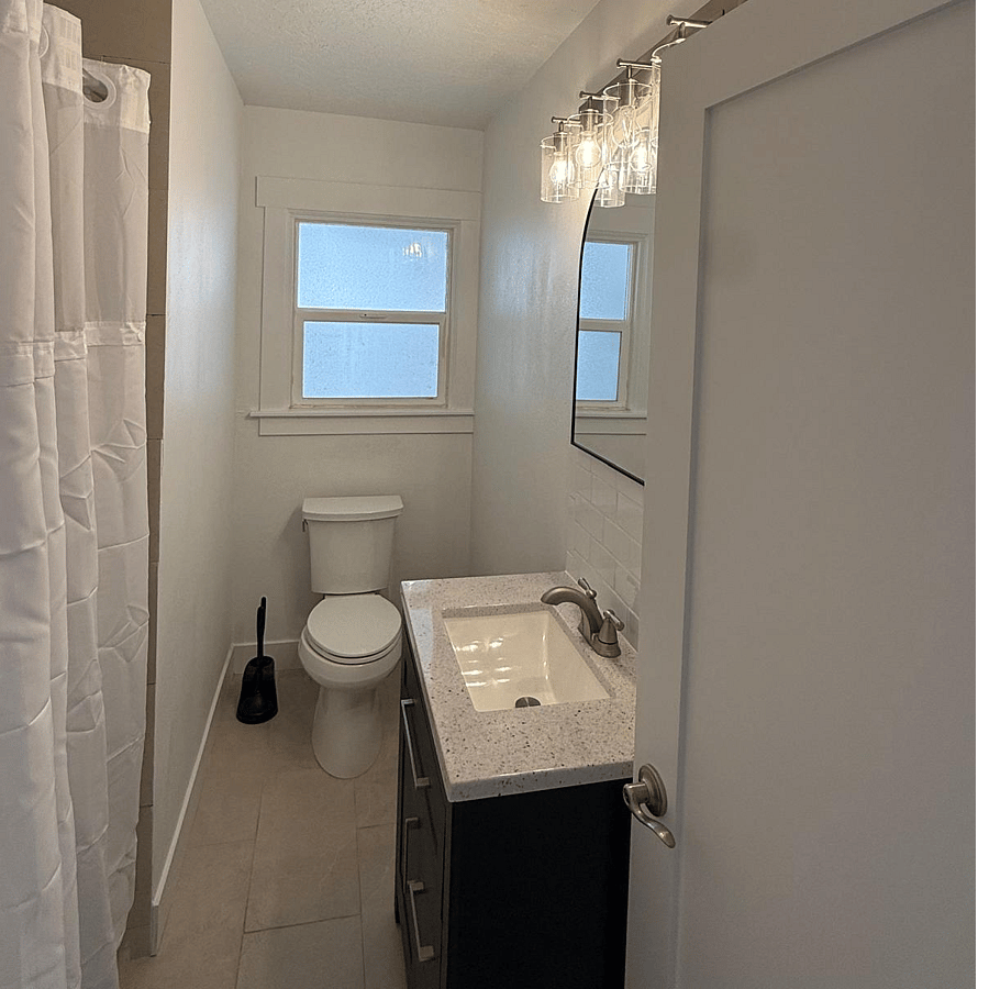 Updated bathroom featuring a bathtub/shower combo and heated floors for added comfort.