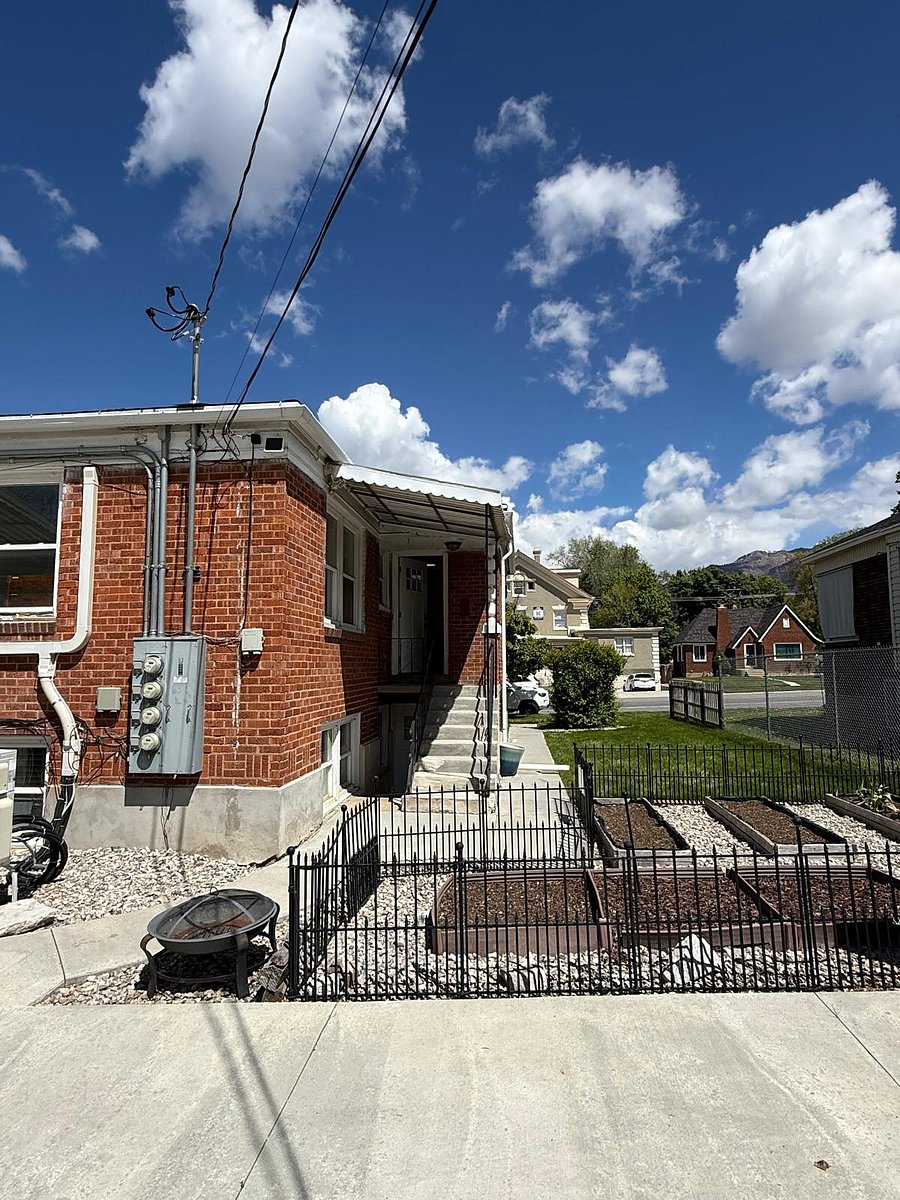 View from the back of the property showcasing the shared garden space, with the top-floor unit entrance and 25th Street visible in the background.
