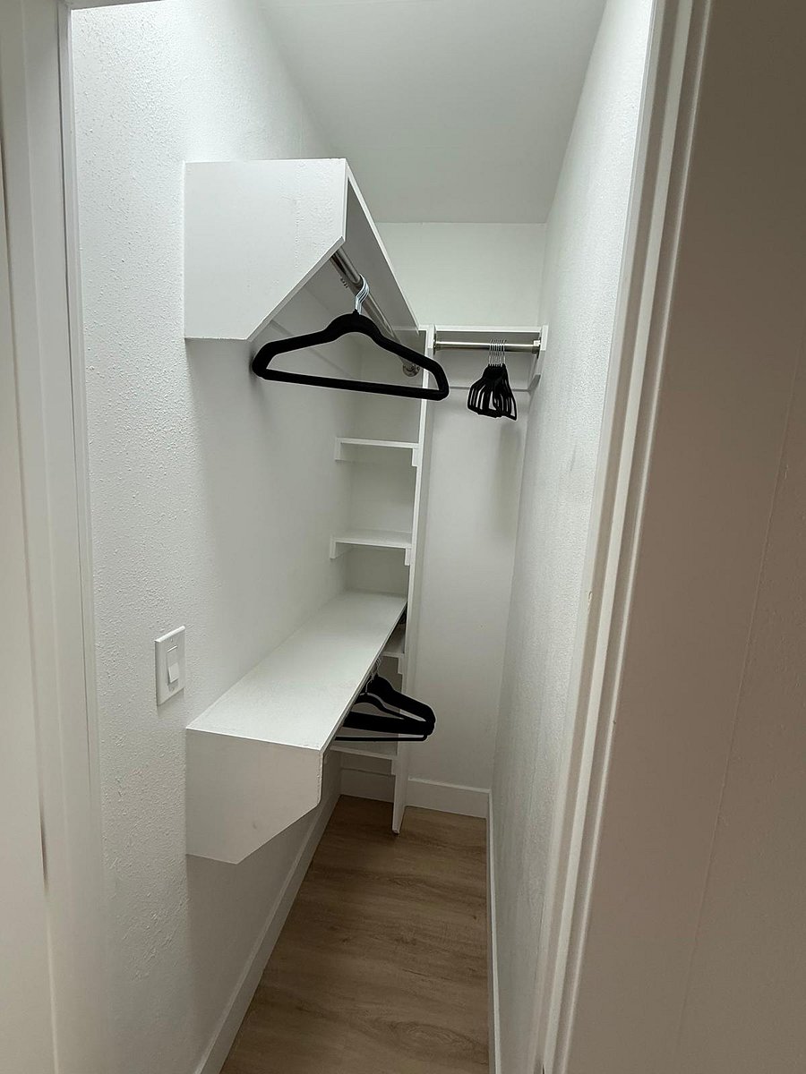 Ample closet space with built-in shelving and storageperfect for organizing clothing, luggage, and personal items.