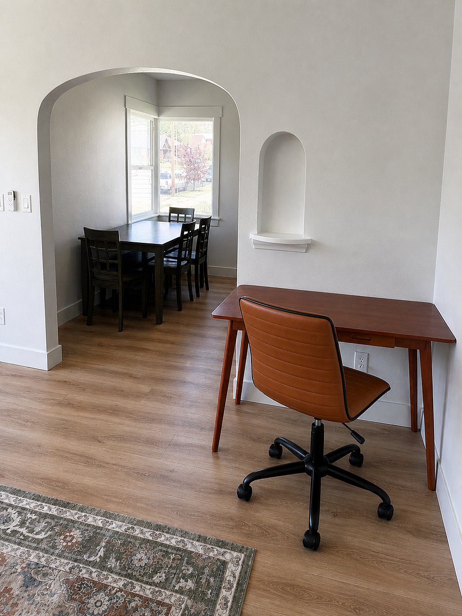 Dedicated work-from-home setup with a spacious desk, comfortable office chair, and great natural lightperfect for remote work.