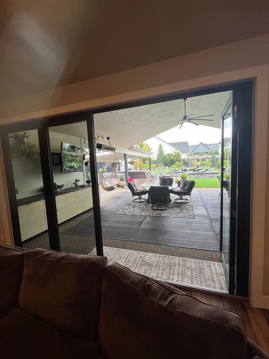 View from great room looking out on hot tub, swim spa and putting green