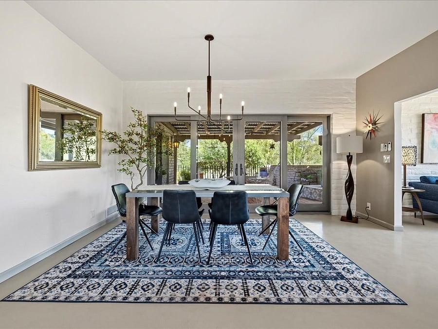 Wonderful dining area with a Crete and Barrel farm style table with views of the desert wash and back patio