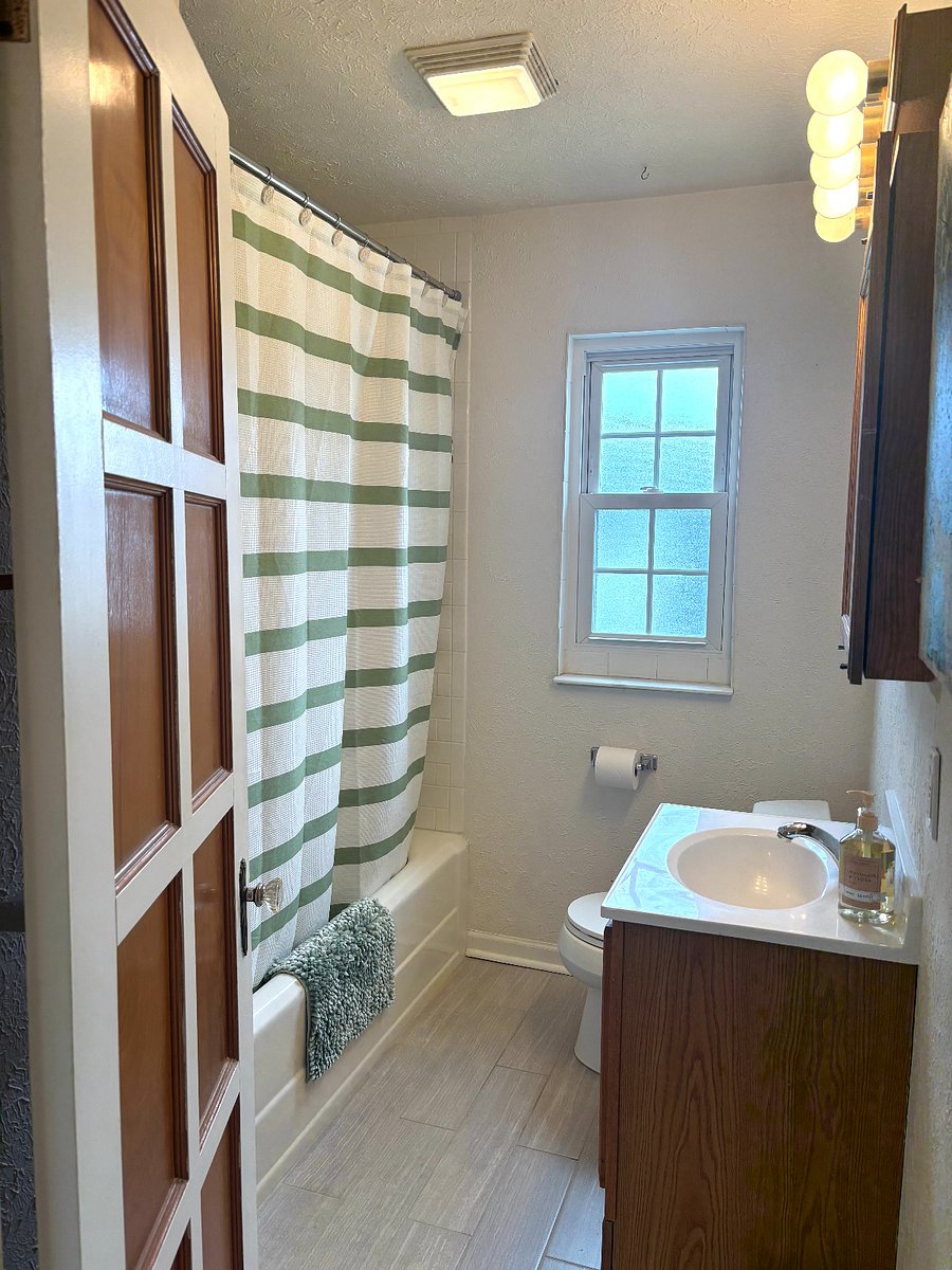 Tiled Bathroom with Shower, window, medicine cabinet and vanity