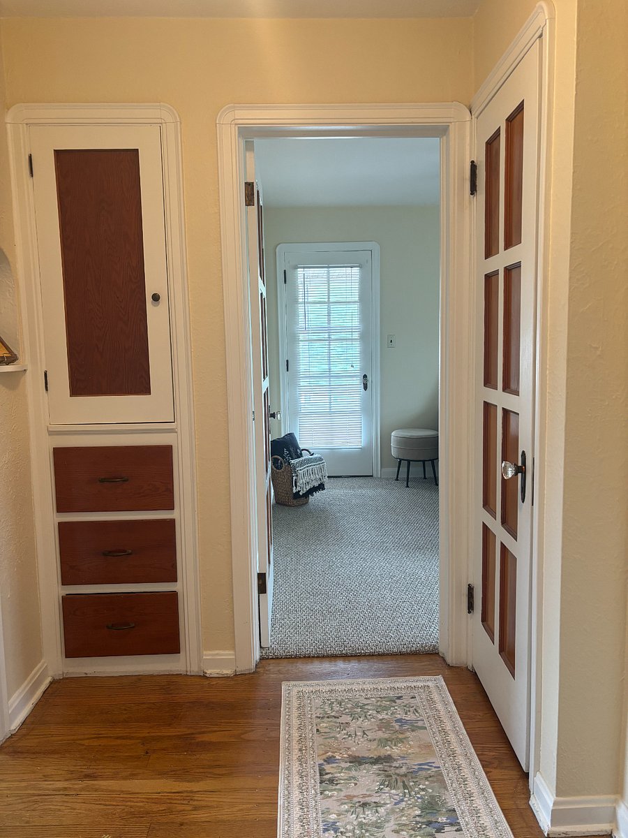 Hallway from kitchen and dining room to bedrooms and bathroom. Large closet to right and big drawers and linen closet