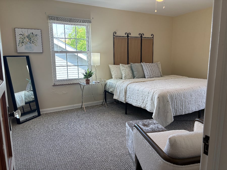 Primary Bedroom with King size bed and door out to screened in porch