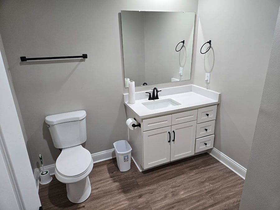Bathroom is roomy and clean.