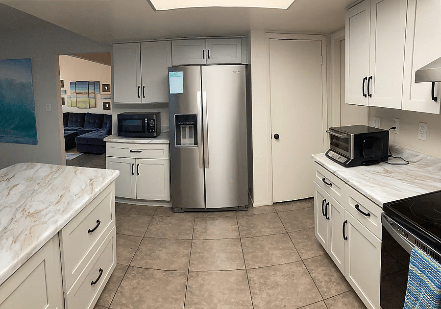 A full-sized refrigerator for dispensed ice and filtered water from a new, whole-house water conditioner and filter.