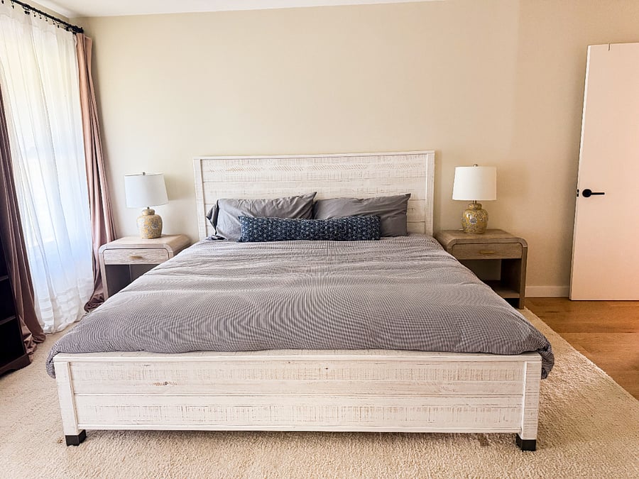 Peaceful primary suite with king bed overlooks backyard