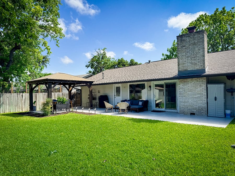 Oasis backyard with dining gazebo, grilling station, and outdoor couch