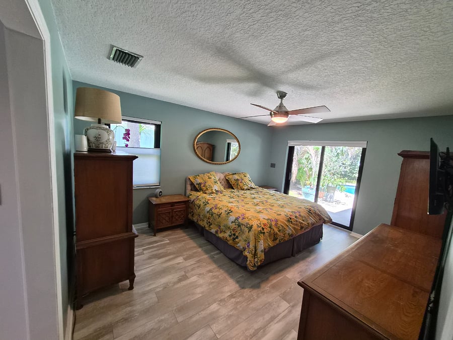 Master bedroom with pool views and access to pool