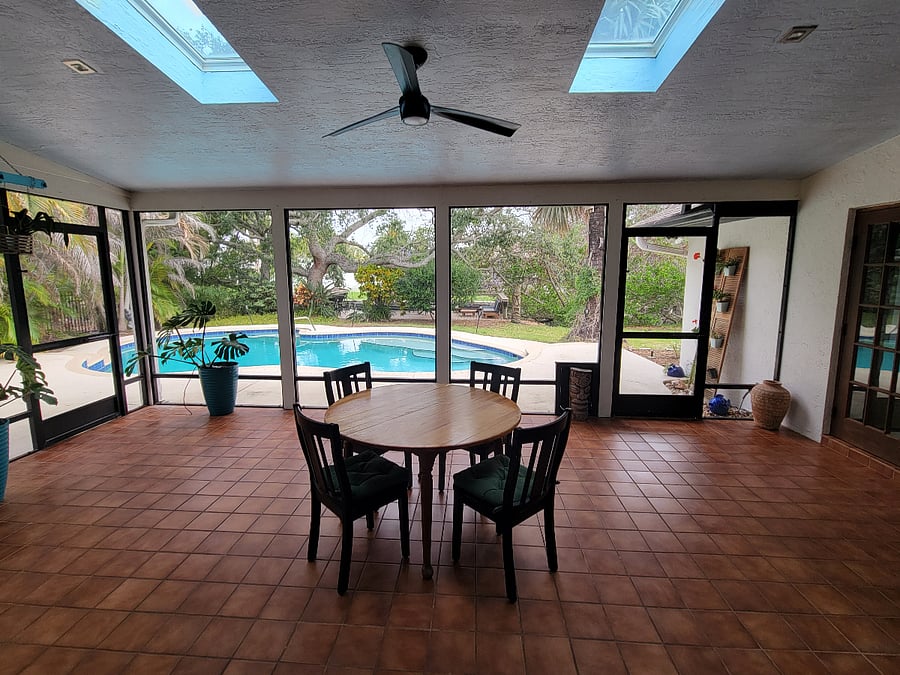 350 sqft screened porch with skylights and great views of the large backyard, pool and canal.