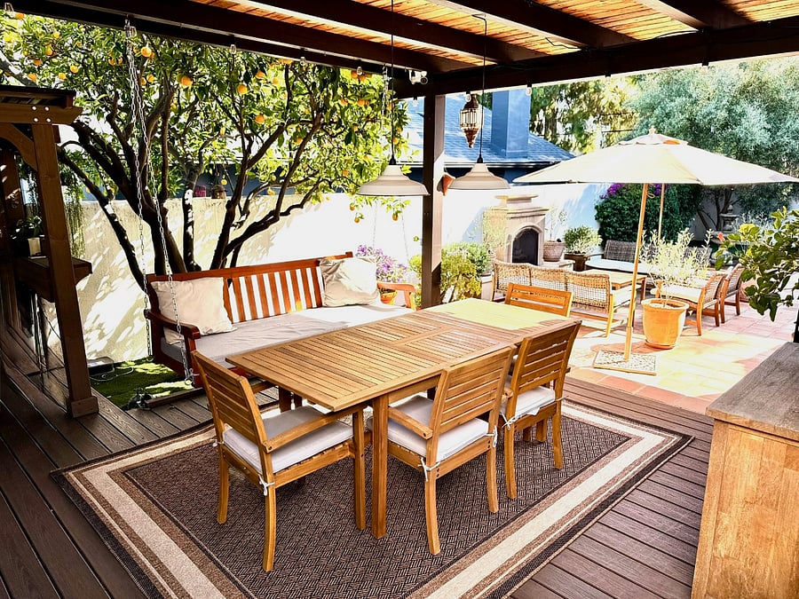 Gazebo patio off the detached studio with a dining table and a porch swing - perfect for lazy summer evenings!
