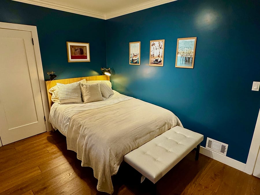 Guest bedroom 2 features a queen bed with desk and closet.