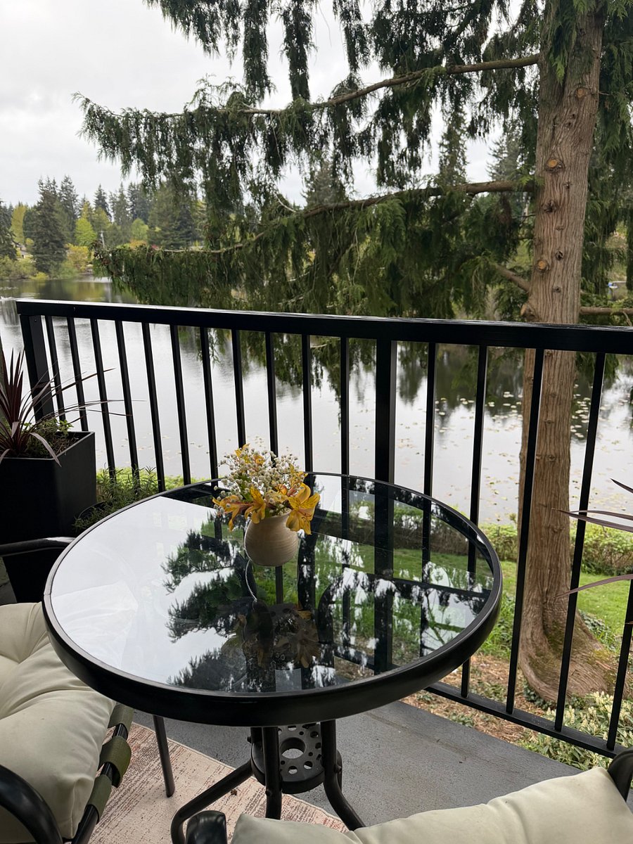 Balcony has table and chairs with lakeside setting for relaxing.