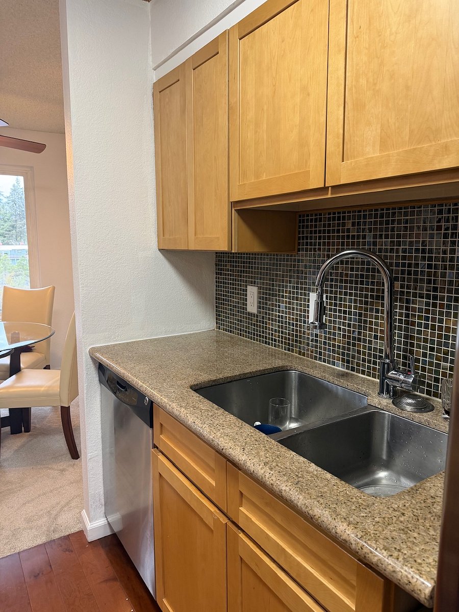 Kitchen features granite counters and stainless appliances.