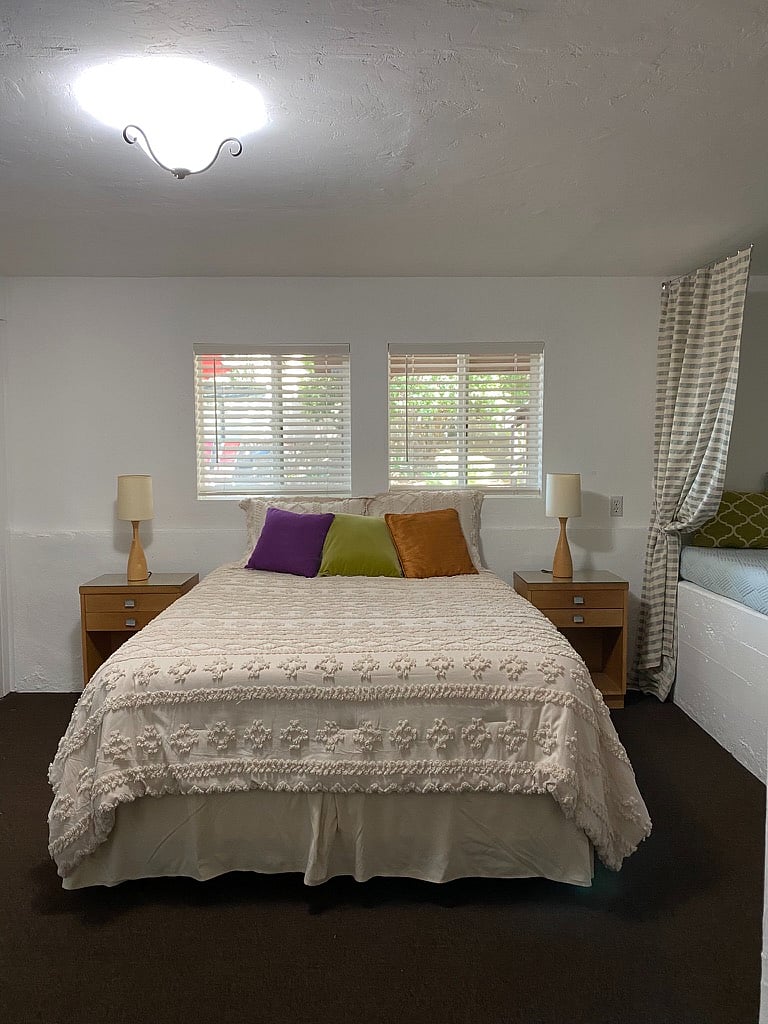 Comfortable queen-size bed next to raised area with double bed