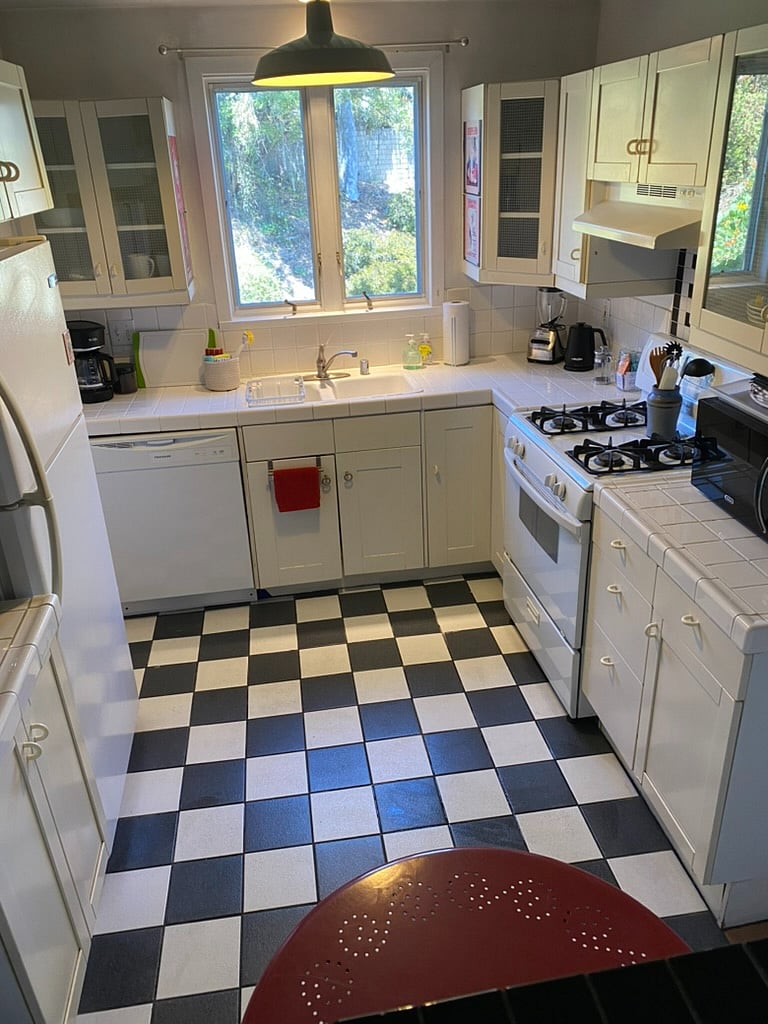 Kitchen with stove, refrigerator, dishwasher, microwave, coffeemaker, etc.  and view of the canyon. 