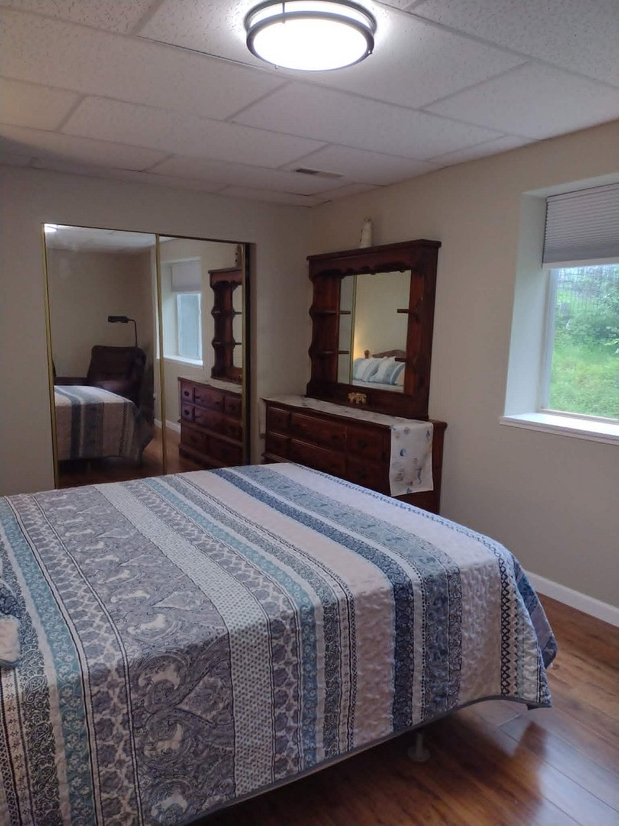 Master bedroom with triple dresser & mirrored hutch top.  Double closet.