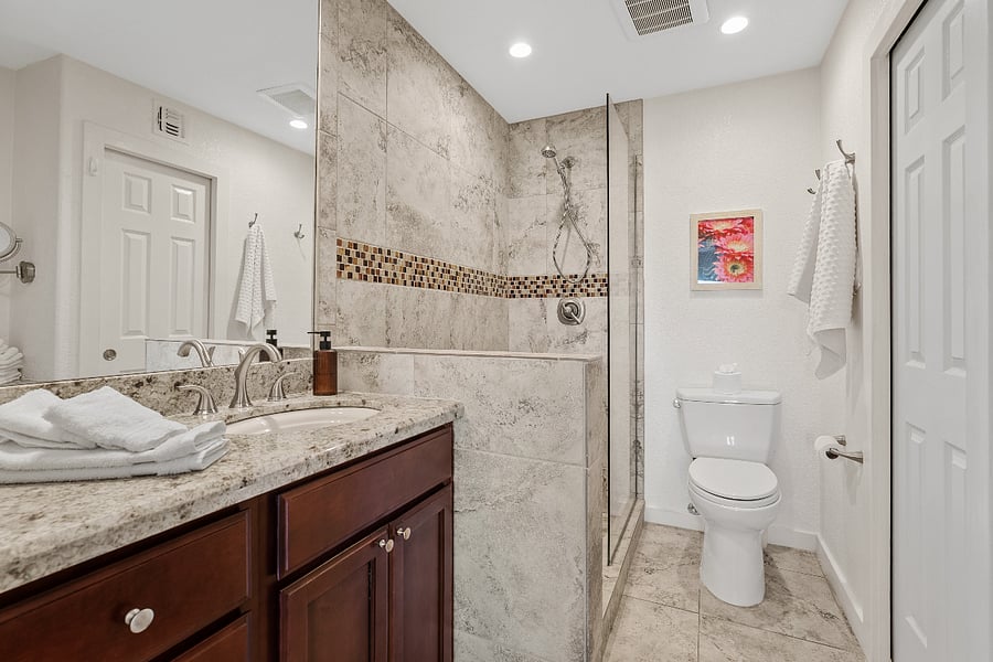 Primary ensuite bathroom with walk-in shower, updated finishes, and a clean, modern feel.