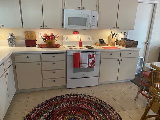 Shared kitchen is fully stocked for two residents with, dishes, glassware, utensils, and more.