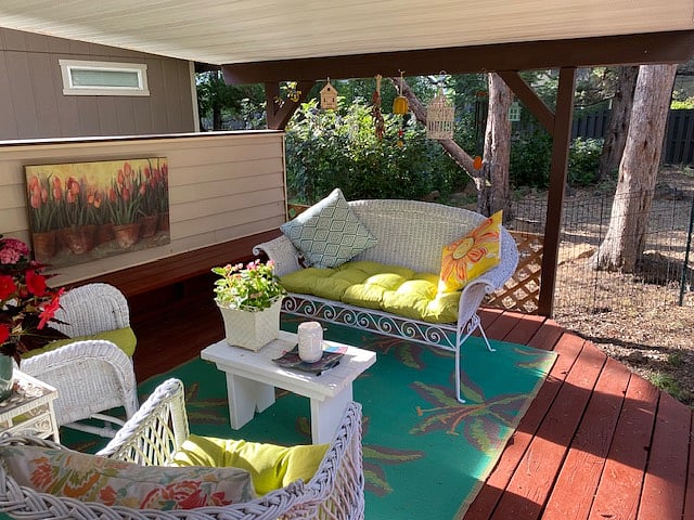 Large deck has a covered sitting area