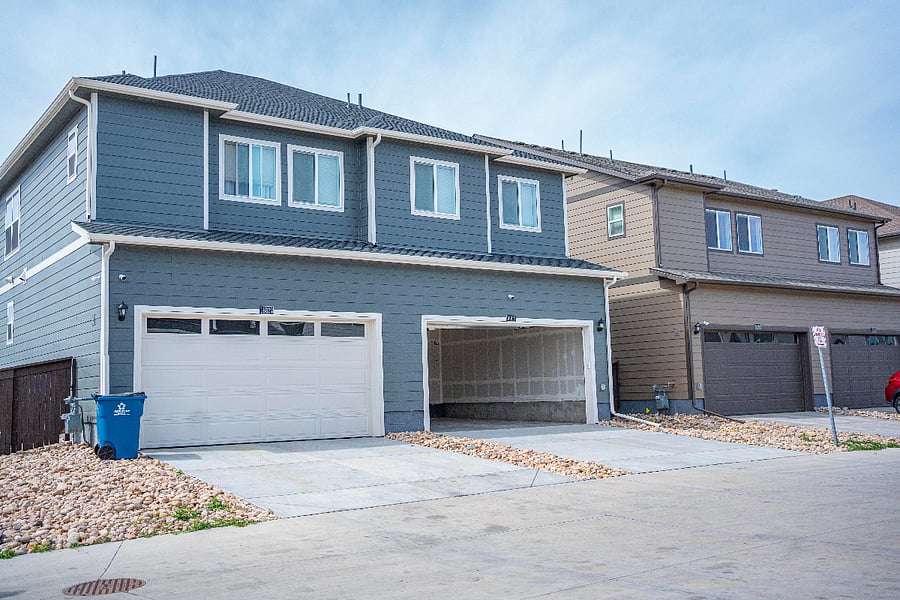 Back facade with garage and driveway 4 cars.