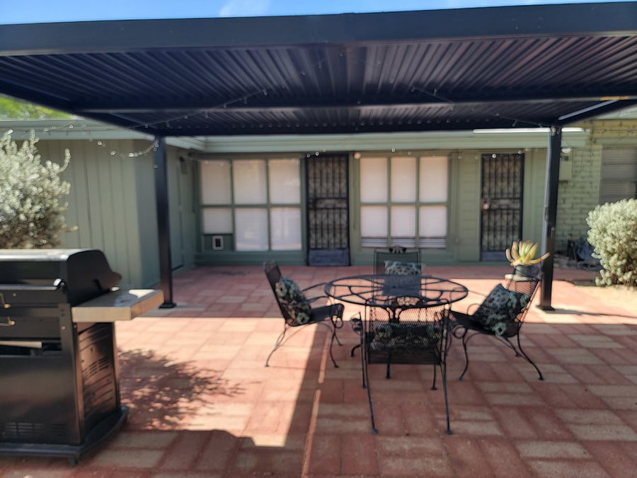 Patio with adjustable louvered shade structure. Perfect for relaxing morning coffee or susnet viewing.