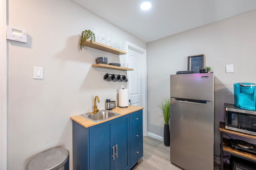 Kitchenette stocked with essentials ( refrigerator, microwave, toaster, conventional oven, salt, pepper, oil, plates, utensils, pots/pans, portable stovetop)