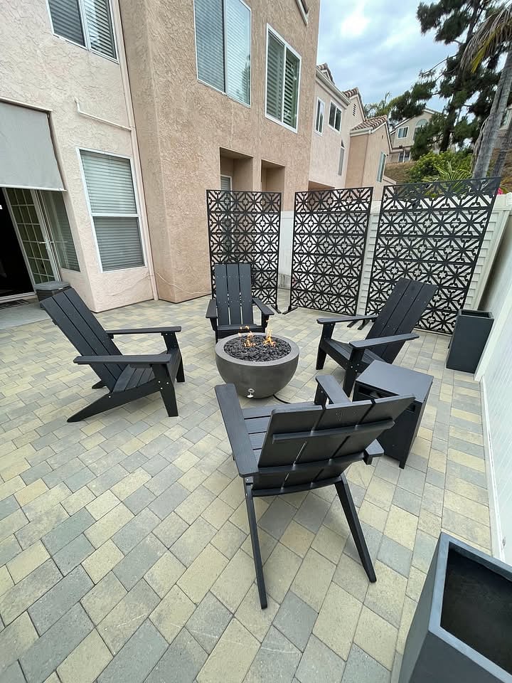 Spacious back patio with fireplace and chairs for you!