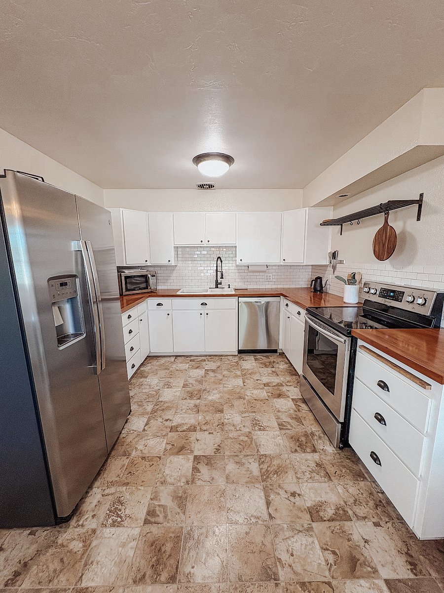 Kitchen with microwave, stove and full size refrigerator and freezer