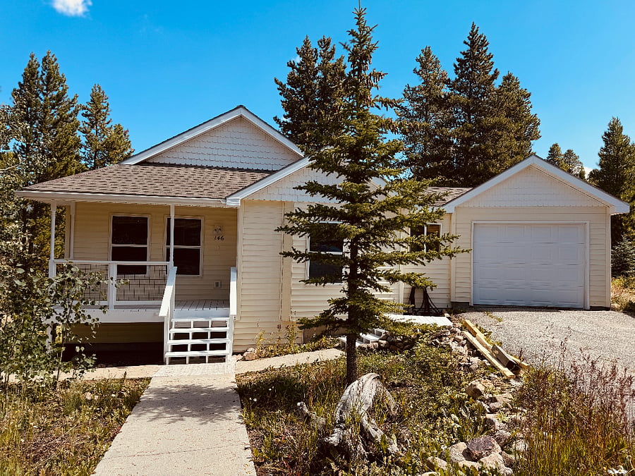 Front of house, with private driveway and garage to the right.