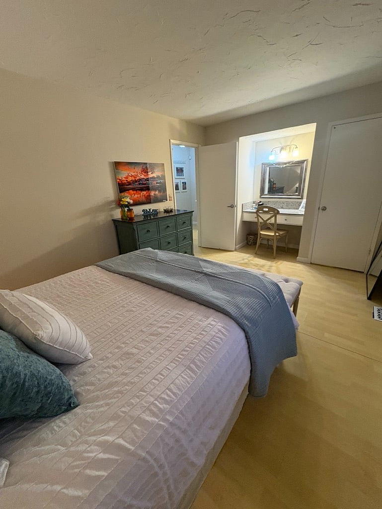 Master bedroom has a designated work or getting ready space
