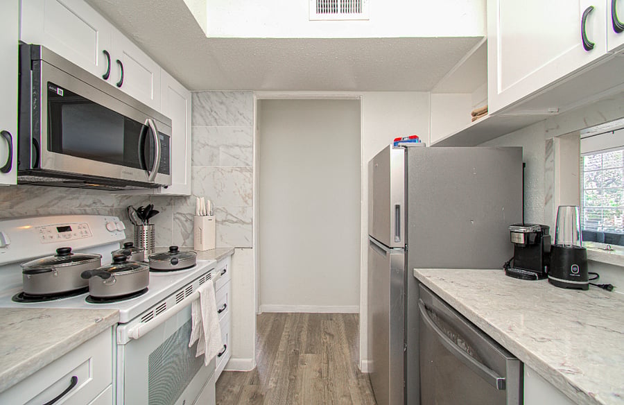 Kitchen with electric stove, dishwasher, microwave and all small appliances
